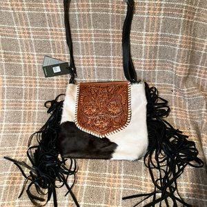 Hand tooled leather hair on hide purse.